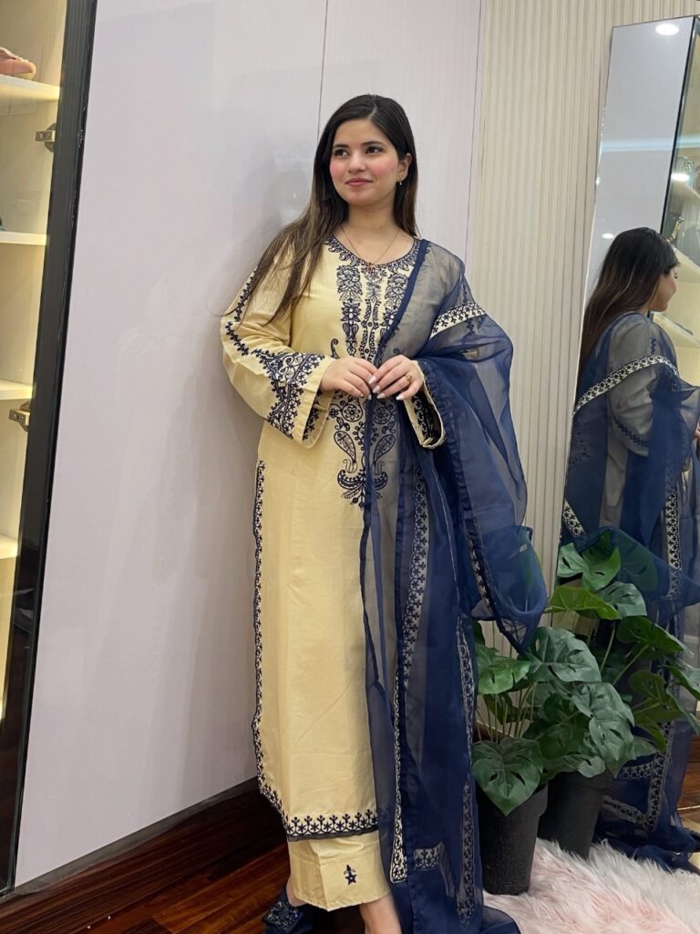 JZARYA flowing neutral-toned abaya styled with gold accessories”